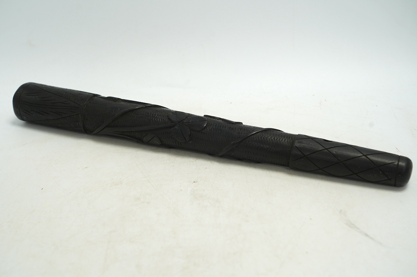 A late 19th/early 20th century Irish bog oak truncheon, carved with a harp and clovers, 37cm in length. Condition - good